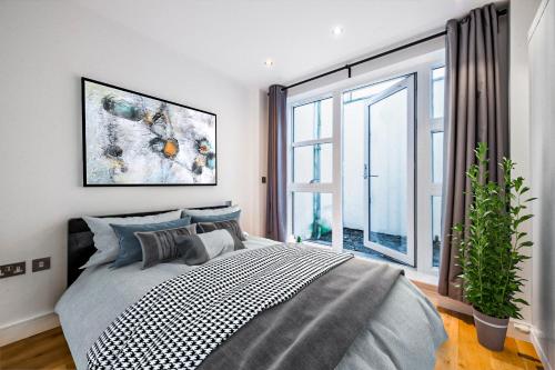 a bedroom with a bed and a large window at 2 Bed Flat in Clapham Common in London