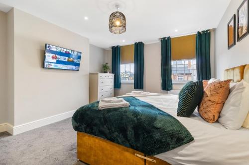 a bedroom with a large bed and a tv at WhiskAwayStays - Victoria House - Apartment 4 in Worcester