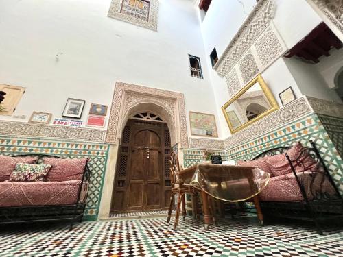a room with a door and a floor with tiles at Dar Sunrise Fes in Fès
