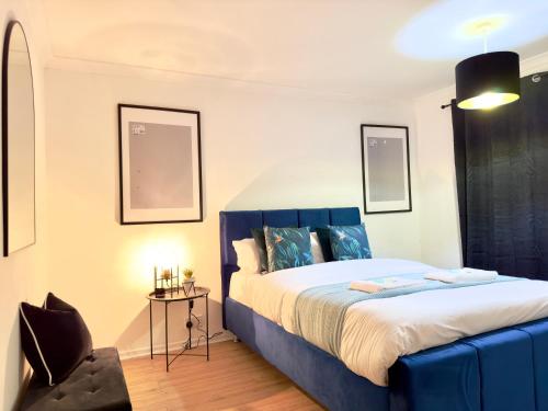a bedroom with a blue bed and a chair at Rooms Near Me - Worcester, Sky Tv, Free Double Parking in Worcester