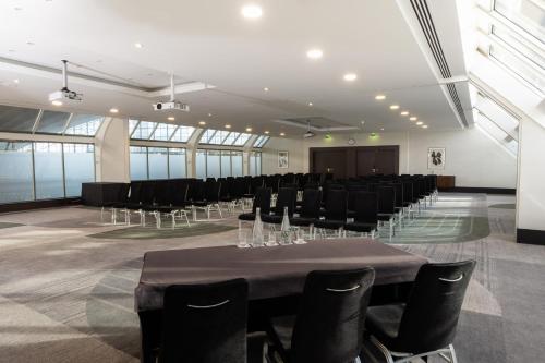 a conference room with a table and chairs at Hilton Paris La Défense in Puteaux