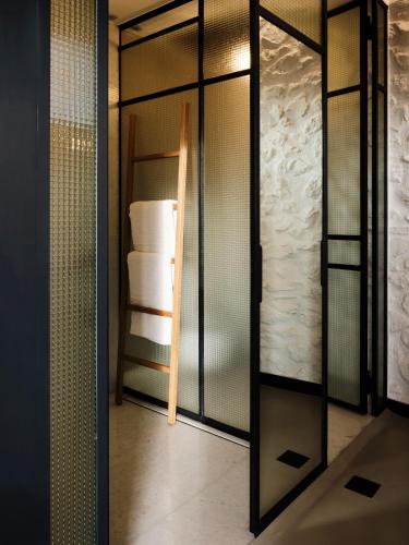 a glass shower door in a bathroom with towels at Not Boutique Hotel in Athens