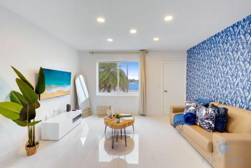 a living room with a couch and a table at Free Parking - Bay View - Pool - Step To Beach in Hollywood