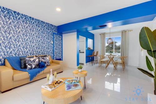 a living room with blue walls and a couch at Free Parking - Bay View - Pool - Step To Beach in Hollywood