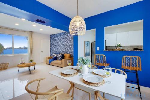 a blue living room with a white table and chairs at Free Parking - Bay View - Pool - Step To Beach in Hollywood