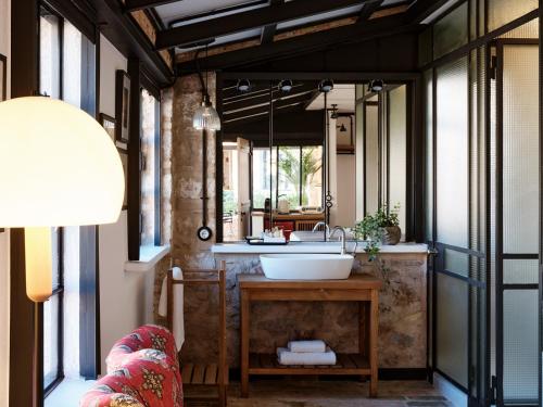 a bathroom with a sink and a large mirror at Not Boutique Hotel in Athens