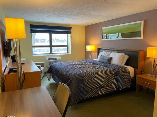 a hotel room with a bed and a table at Lakeside Inn in Wakefield