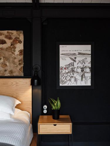 a bedroom with a bed and a table with a plant at Not Boutique Hotel in Athens