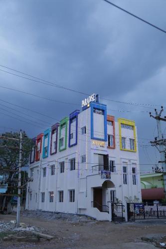 a large white building with colorful windows on it at PARADISE BANQUET HALL & A/C ROOMS in Madurai