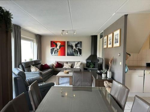 a living room with a couch and a table at Crox Houcke 24* in Nieuwvliet