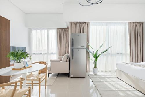 a kitchen and living room with a refrigerator at Silkhaus Vacation Homes Luxury Studio in Residential Neighborhood in Dubai