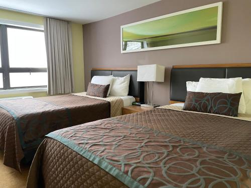 a hotel room with two beds and a window at Lakeside Inn in Wakefield