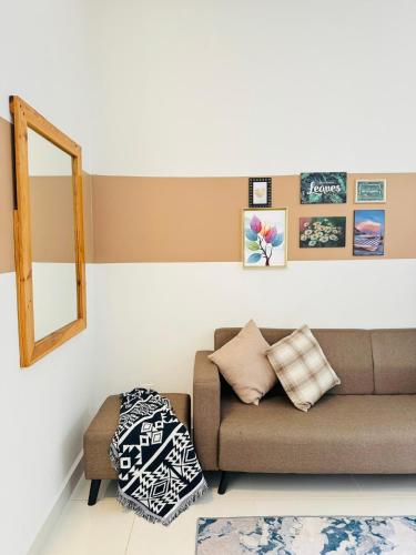a living room with a couch and a mirror at CoreSoho Suite by BKAstaycation KotaWarisan Sepang KLIA Airport, Free Wifi in Sepang
