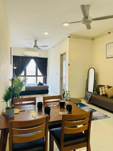 a living room with a table and chairs and a bed at CoreSoho Suite by BKAstaycation KotaWarisan Sepang KLIA Airport, Free Wifi in Sepang