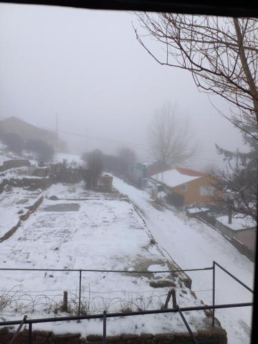 a field covered in snow in a town at Casa Serrana in Penhas da Saúde