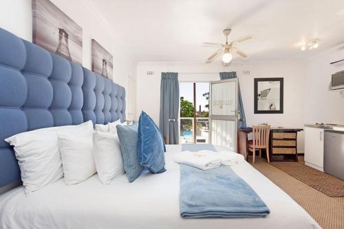 a blue and white bedroom with a large bed at Kwantu Guesthouse 1 in Cape Town