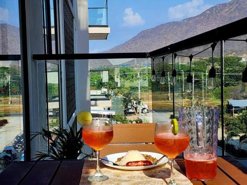 una mesa con dos copas de vino y un plato de comida en Loft completo con balcón a 5 min de la playa, en Santa Marta