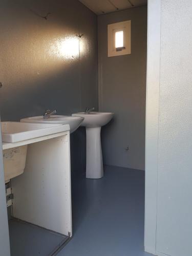 a bathroom with two sinks and a mirror at La Eriba Puck in Nort-sur-Erdre