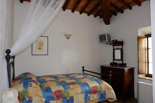 a bedroom with a bed and a dresser and a window at Tenuta Il Tresto in Poggibonsi