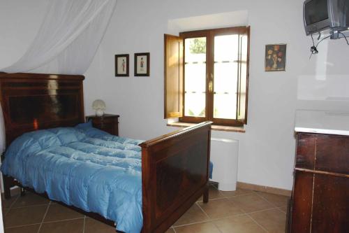 a bedroom with a bed and a window and a television at Tenuta Il Tresto in Poggibonsi