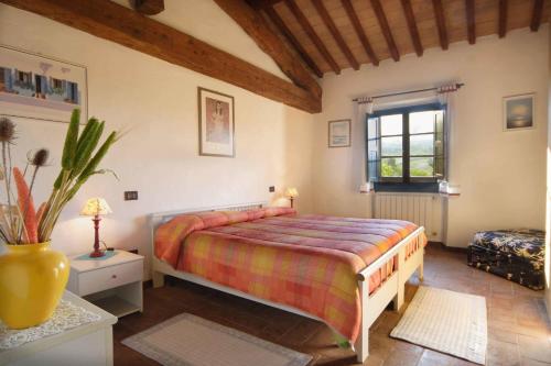 a bedroom with a large bed and a window at Tenuta Il Tresto in Poggibonsi