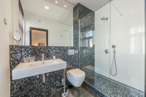 a bathroom with a sink and a shower at Starlight Luxury Rooms in Split