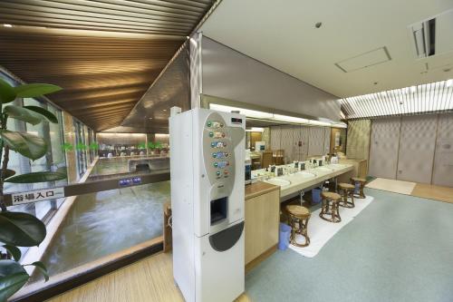 a restaurant with a large refrigerator in the middle of a room at Minakami Hotel Juraku in Minakami