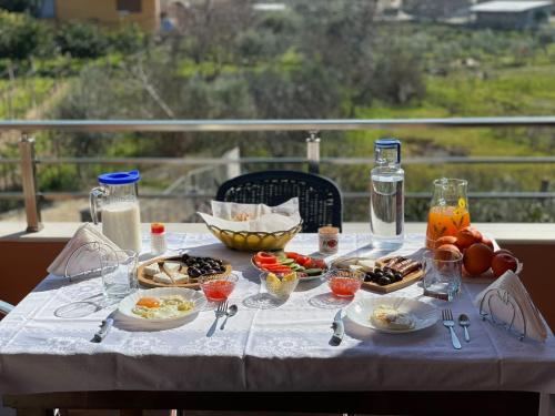 a table with plates of food and drinks on it at Harmony Villa Berat in Berat