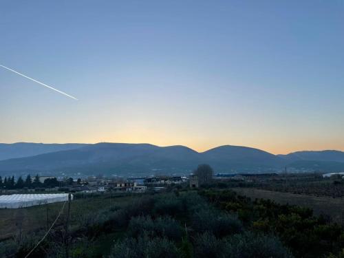 a sunset over a city with mountains in the background at Harmony Villa Berat in Berat