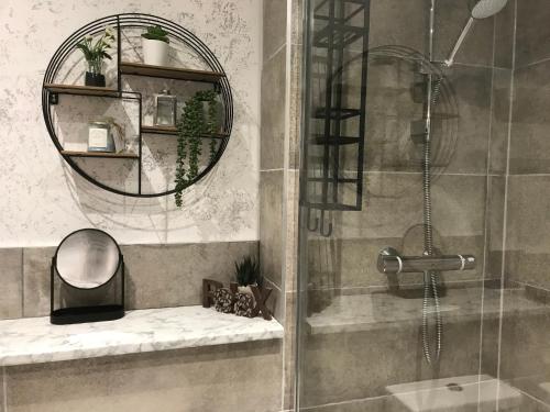a bathroom with a shower and a mirror at Swanning Off Whitby with Parking in Whitby