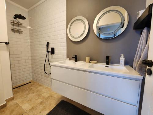 a bathroom with a white sink and a mirror at Quay Five on the Waterfront in Knysna