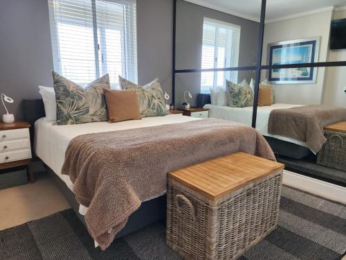 a bedroom with a large bed and a window at Quay Five on the Waterfront in Knysna