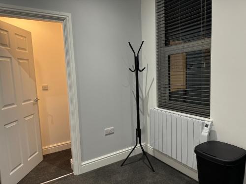 a room with a tripod next to a window at Herne Bay 2-Bedroom House with Private Hot Tub & Garden, Walk to Seafront in Kent