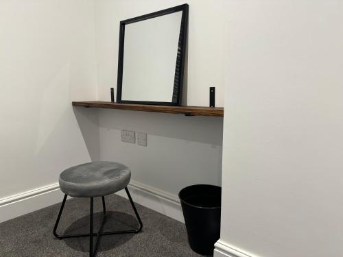 a stool in a room with a mirror on a shelf at Herne Bay 2-Bedroom House with Private Hot Tub & Garden, Walk to Seafront in Kent