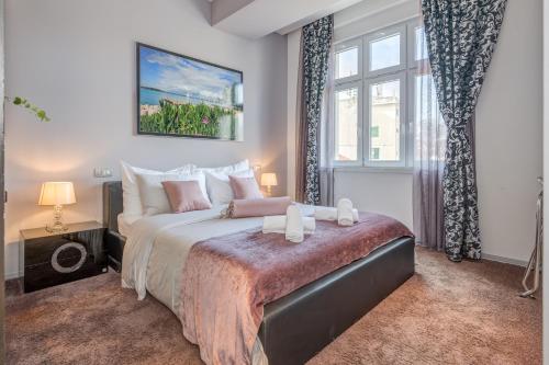 a bedroom with a large bed and a window at Starlight Luxury Rooms in Split