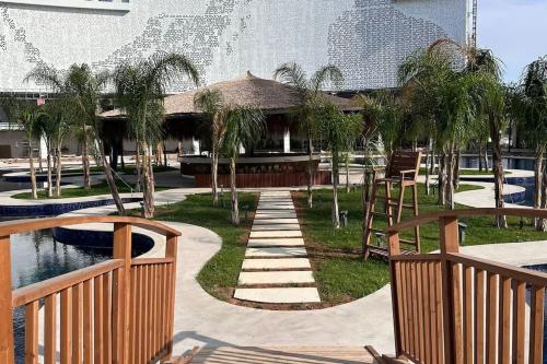 a resort with a pool and a building with palm trees at 2 Bedroom Amazing sea view Grand Sapphire in Iskele