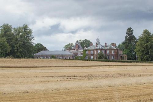 a large house in the middle of a field at Solberge Hall in Northallerton