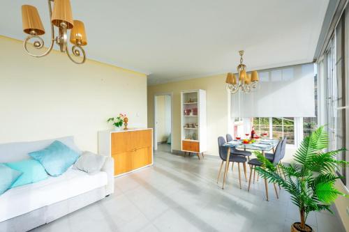a living room with a white couch and a table at Villa Marrakech con Pisicina privada y vistas al mar by At Home Costa del Sol in Torrox Costa
