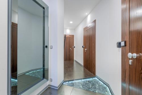 a hallway with a glass walkway and a door at Starlight Luxury Rooms in Split