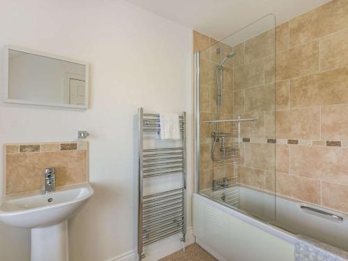 a bathroom with a shower and a sink and a tub at 3 Bed in Bridlington 56248 in Weaverthorpe