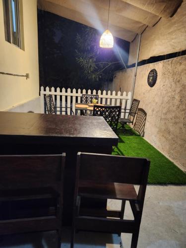 a dining room with a table and chairs and a green floor at La casa de la Gaviota in Siguatepeque