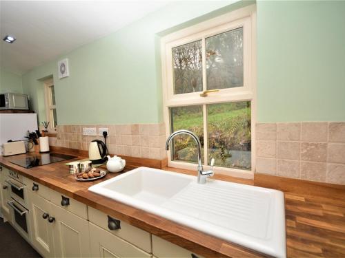 a kitchen with a sink and a window at 1 Bed in Ballantrae 45713 in Ballantrae