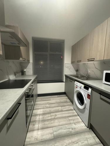 a kitchen with a washing machine and a window at P Williams in Catford