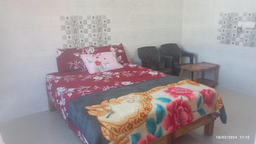 a bedroom with a bed and a table and chairs at SAI homestay in Hospet