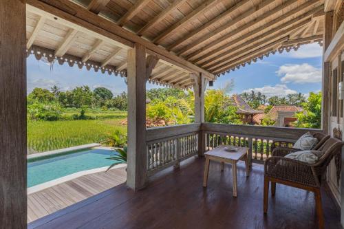 a porch of a house with a pool at Billys Ayodya Villa in Perean