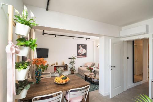 a living room with a table with a bowl of fruit on it at Apartments Alex in Dubrovnik