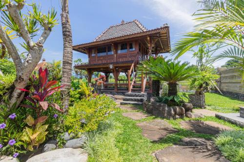 a house in the middle of a garden at Billys Ayodya Villa in Perean