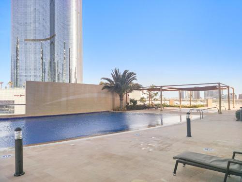 a swimming pool in a city with tall buildings at Silkhaus Sea View studio in Marina Rise Tower in Abu Dhabi