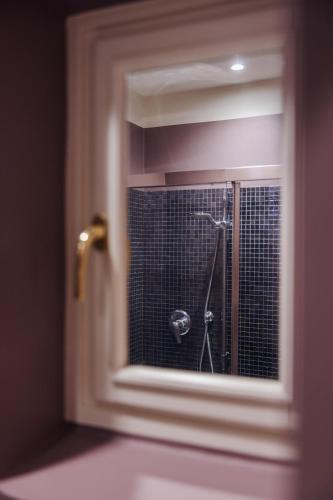 a reflection of a shower in a bathroom window at Palazzo Dalla Rosa Prati in Parma