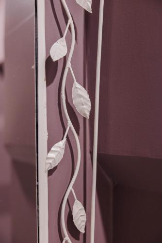 a plant with white leaves on a pink wall at Palazzo Dalla Rosa Prati in Parma
